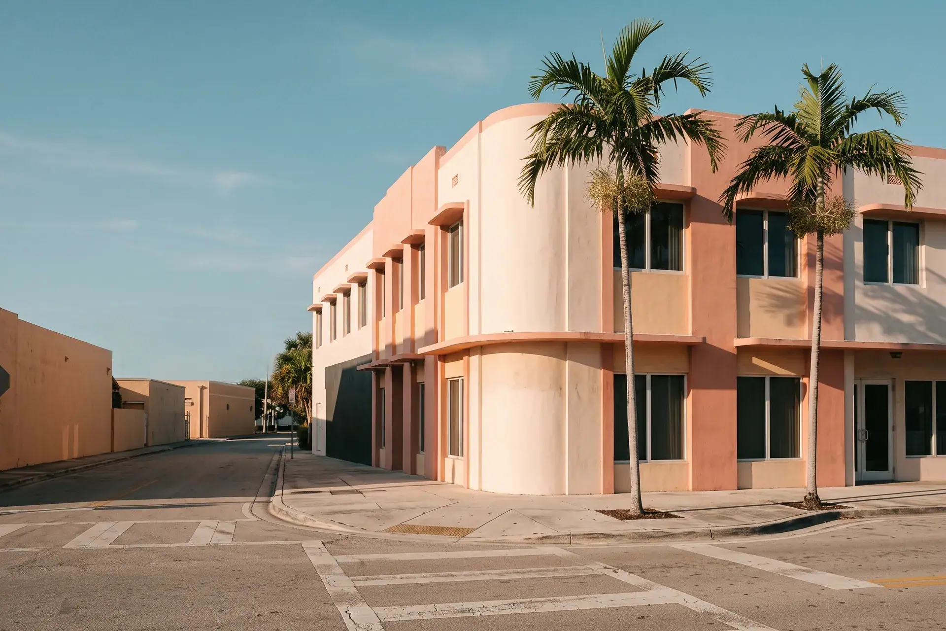 A bright Miami street corner with palm trees in soft morning light